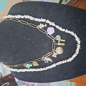 Bundle of Pale Pink Puka Shell necklace and charm necklace.